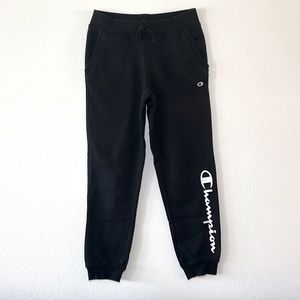 Girls black fleece lined Champion athletic sweatpants with side pockets.
